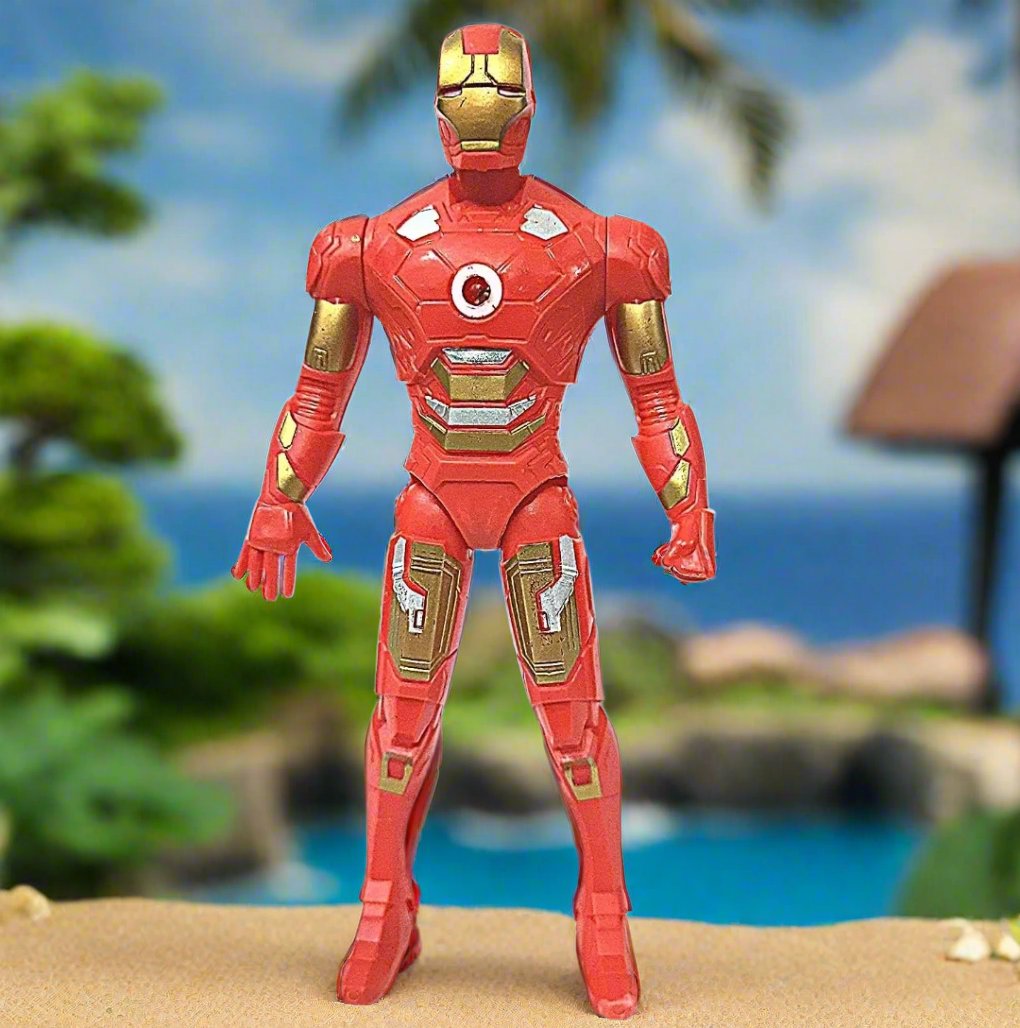 The image showcases Iron Man's stunning house located in a secluded coastal area, perched on a cliff overlooking the serene ocean. The architecture features a modern, sleek design with large glass windows that reflect the brilliant blue sky and the sparkling water below. The house is surrounded by lush greenery, including tall trees and manicured lawns, creating a harmonious blend of nature and technology. In the foreground, you can see a winding pathway leading up to the entrance, flanked by vibrant flower