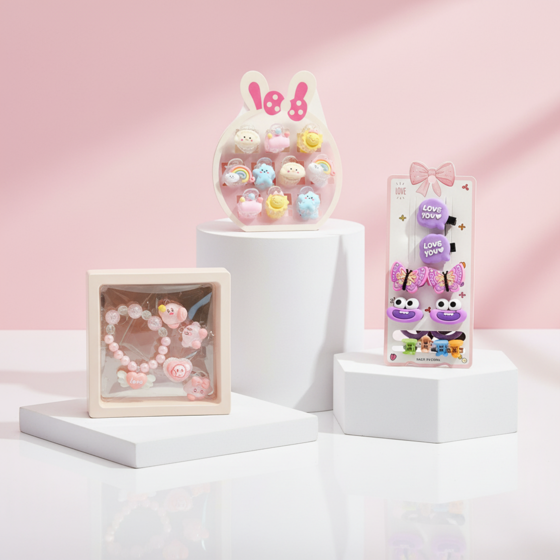 Girls Accessories Combo – Baby Hair Clips bunny display, Princess Bracelet gift box, Hair Clips card on white pedestals with pink background