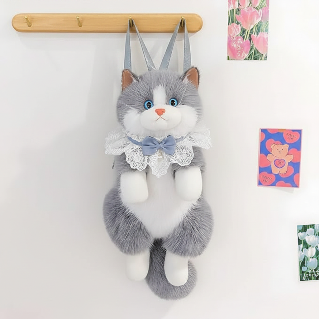 Grey cat backpack hanging on wall hook with postcards